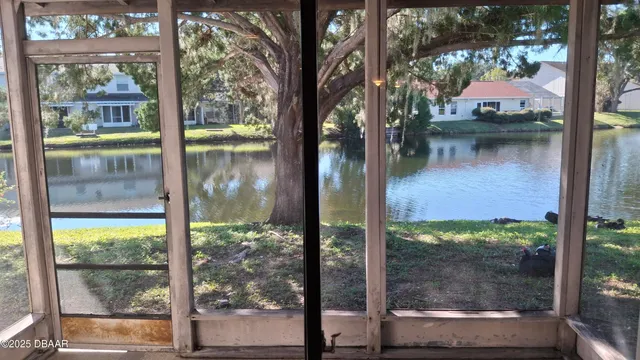 a view of a porch with furniture and a yard