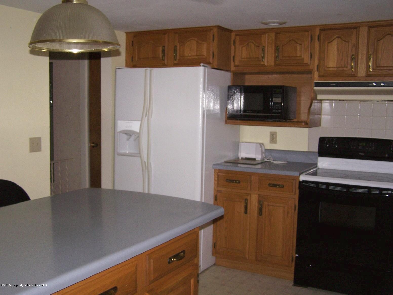 290 Patton Hill Road Le Raysville, PA 18829 - Photo 8 of 42 a kitchen with stainless steel appliances a stove microwave and refrigerator
