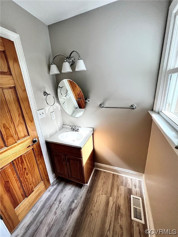4600 Centralia Road Chester, VA 23831 - Photo 12 of 32 Bathroom featuring hardwood flooring, vanity with extensive cabinet space, and mirror