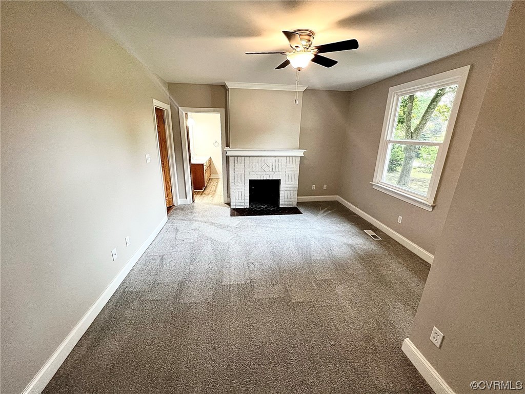 4600 Centralia Road Chester, VA 23831 - Photo 17 of 32 Carpeted living room featuring ceiling fan and a fireplace