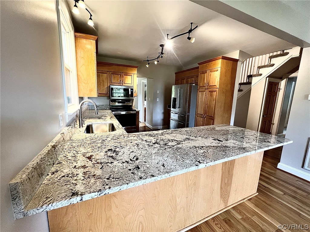 4600 Centralia Road Chester, VA 23831 - Photo 5 of 32 Kitchen with brown cabinets, light stone countertops, hardwood flooring, stainless steel appliances, and rail lighting