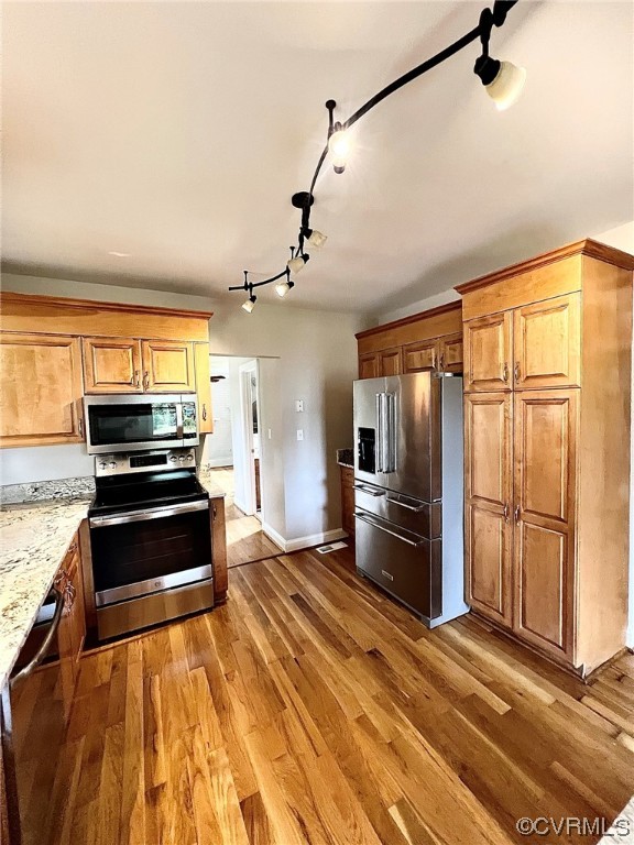 4600 Centralia Road Chester, VA 23831 - Photo 9 of 32 Kitchen with light parquet floors, brown cabinets, light countertops, appliances with stainless steel finishes, and track lighting