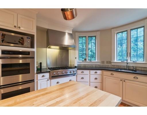 204 Nashawtuc Road Concord, MA 01742 - Photo 7 of 30 a kitchen with stainless steel appliances granite countertop a stove and a sink