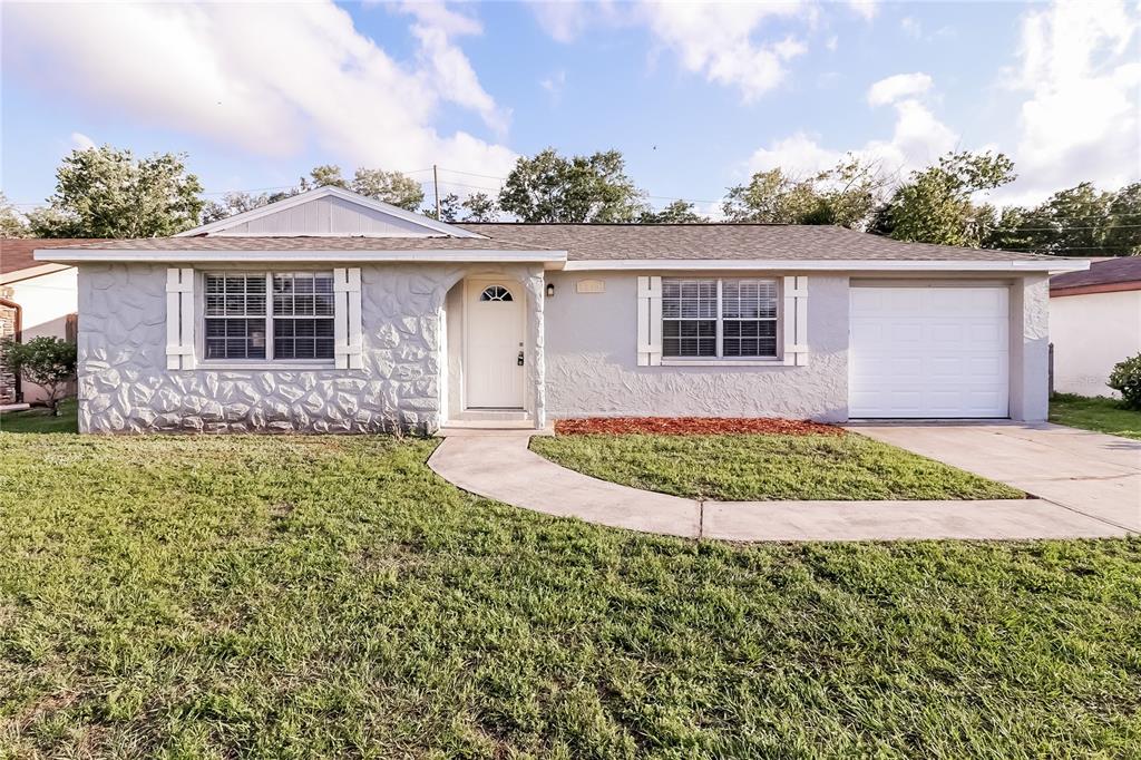 6230 Westport Drive Port Richey, FL 34668 - Photo 2 of 15 front view of a house with a yard
