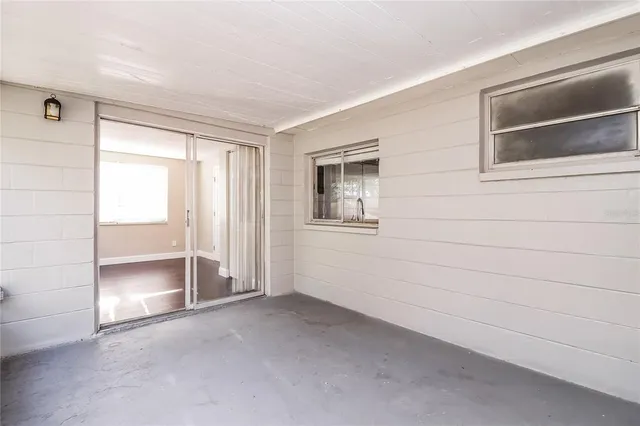 a view of empty room with cabinet and refrigerator
