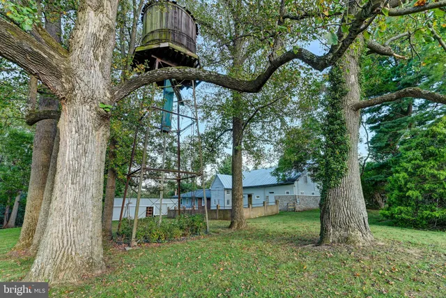 a view of an empty room with wooden floor and windows