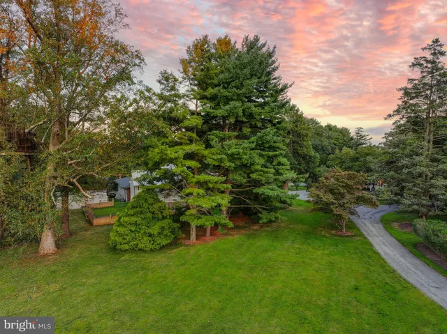 an aerial view of a residential houses with yard