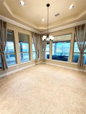 a view of an empty room with a fireplace and a window