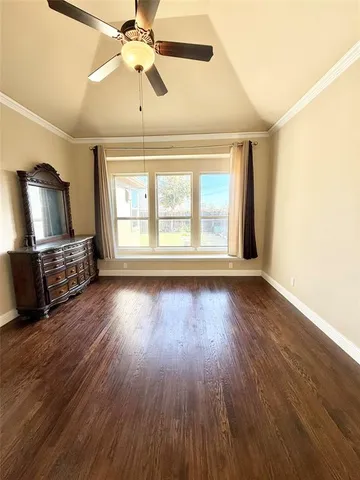 a view of a livingroom with wooden floor window and a kitchen