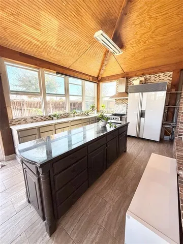 a kitchen with stainless steel appliances granite countertop a stove and a wooden floors