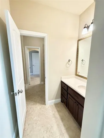 a view of bathroom with a sink and mirror