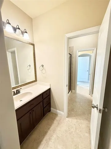 a bathroom with a sink vanity and mirror