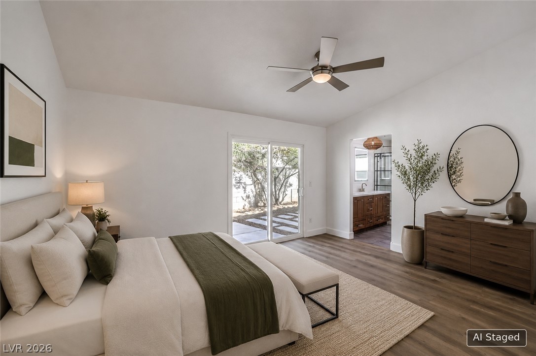 1900 Cardinal Point Street Henderson, NV 89012 - Photo 12 of 32 Sliding glass doors offer seamless access to the outdoors, complementing the warm flooring and natural light in this primary bedroom.