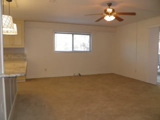 a living room with furniture a chandelier and a window