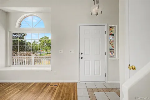 a view of a livingroom with wooden floor and a window