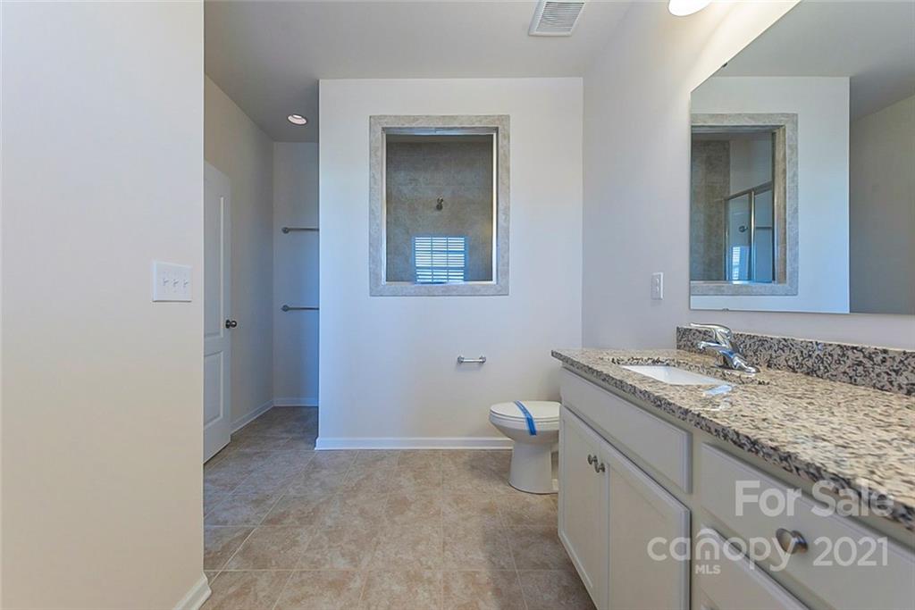 541 Dulaney Drive Fort Mill, SC 29708 - Photo 6 of 16 a bathroom with a granite countertop sink and a mirror