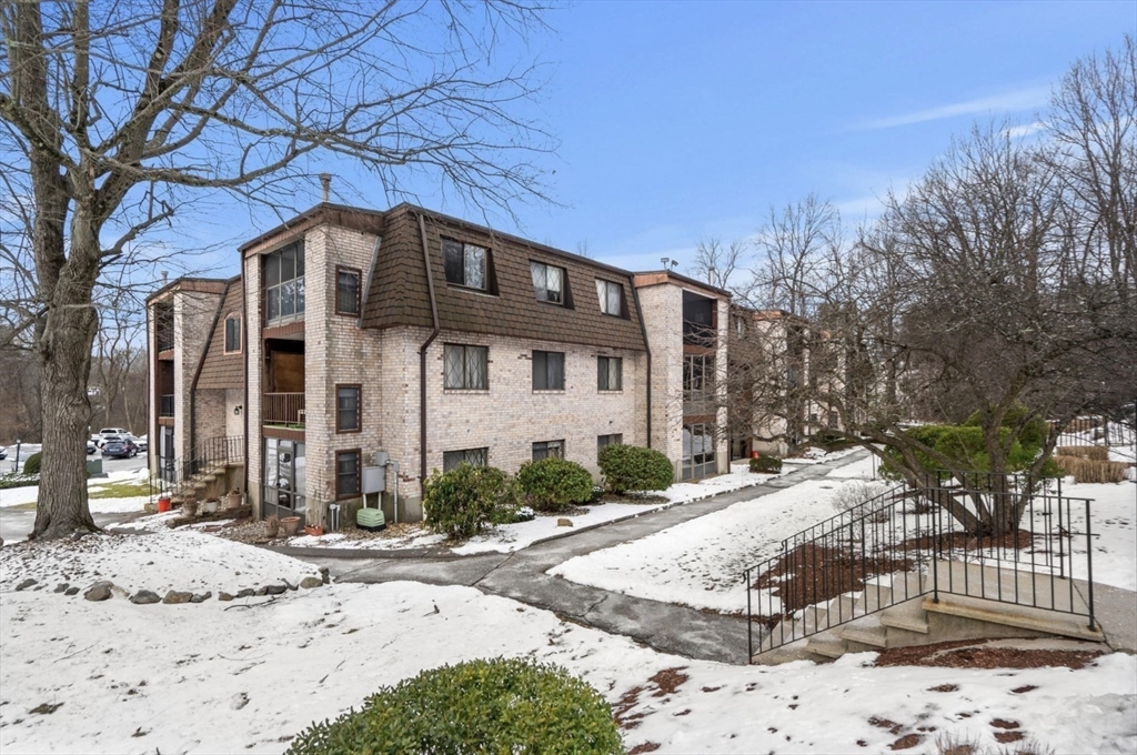 7 Greenbriar Drive, Unit 304 North Reading, MA 01864 - Photo 1 of 23 a front view of a house with a yard