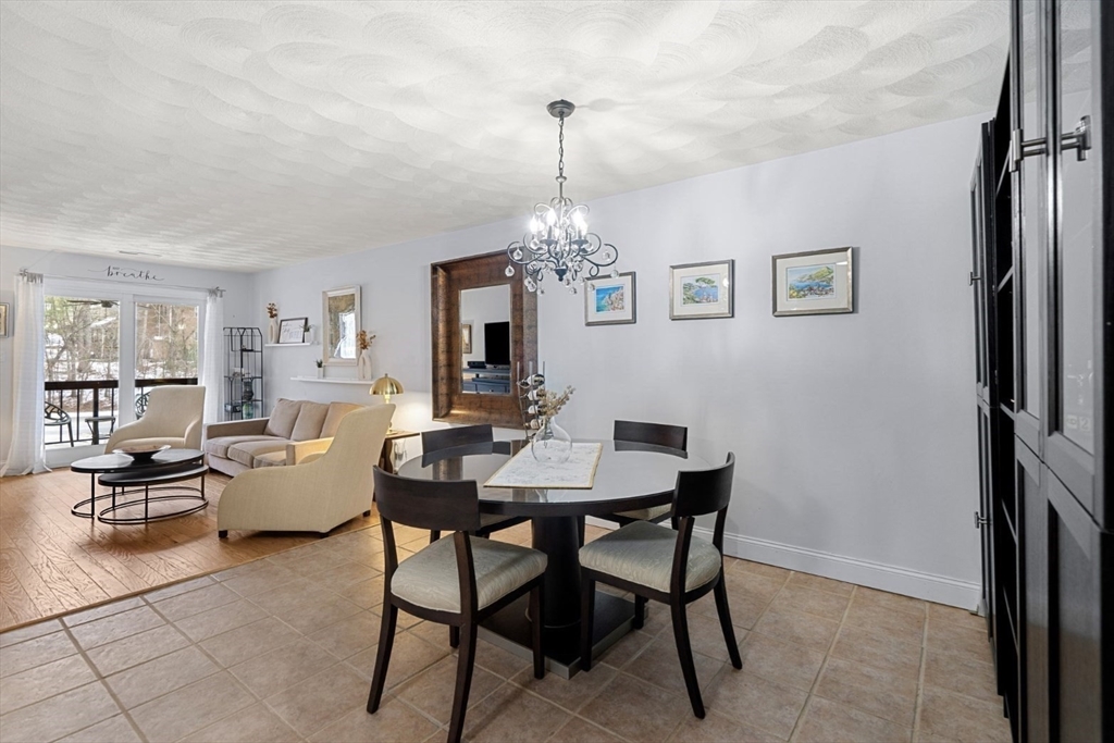 7 Greenbriar Drive, Unit 304 North Reading, MA 01864 - Photo 13 of 23 a view of a dining room with furniture window and wooden floor