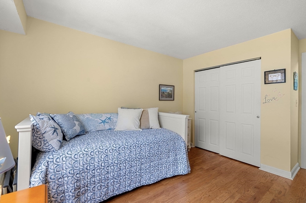 7 Greenbriar Drive, Unit 304 North Reading, MA 01864 - Photo 16 of 23 a living room with a couch and a table