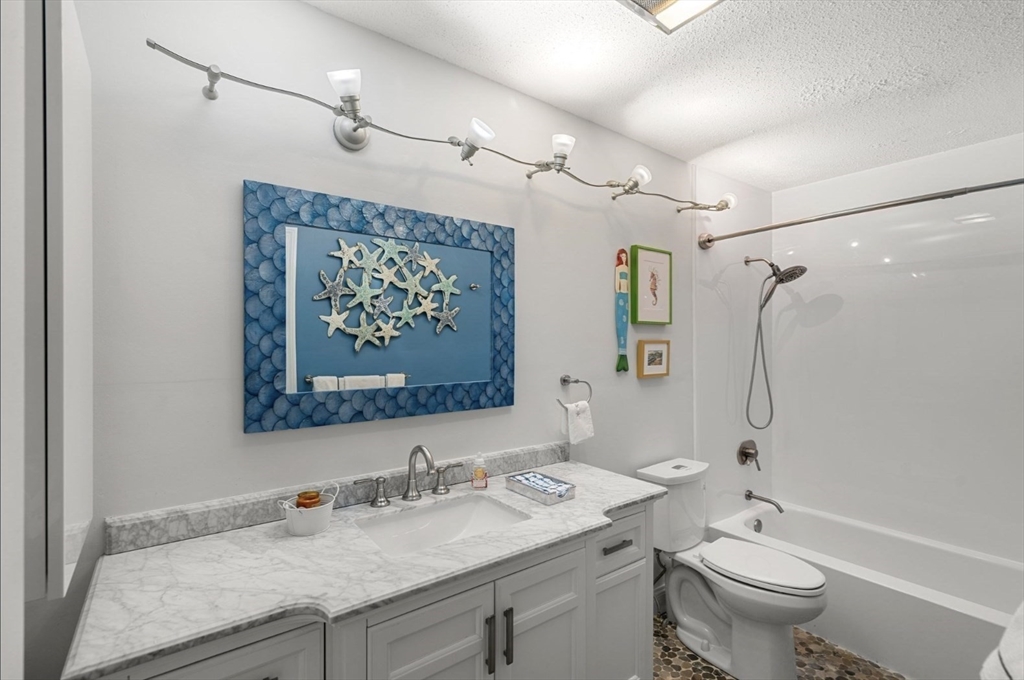 7 Greenbriar Drive, Unit 304 North Reading, MA 01864 - Photo 19 of 23 a bathroom with a granite countertop sink toilet and shower