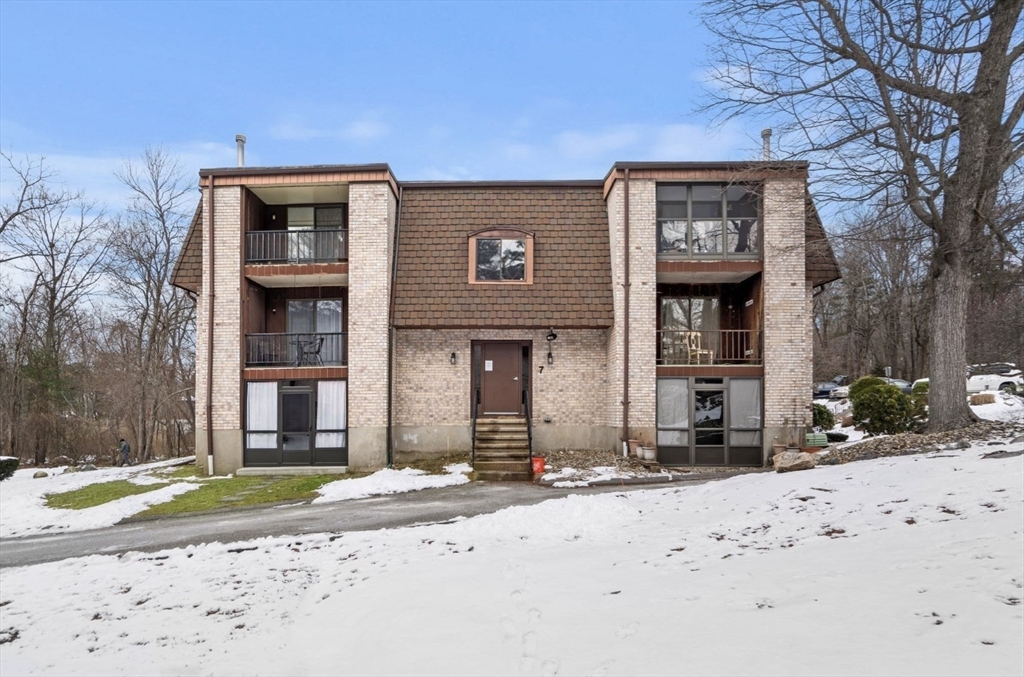 7 Greenbriar Drive, Unit 304 North Reading, MA 01864 - Photo 21 of 23 a front view of a house with a yard