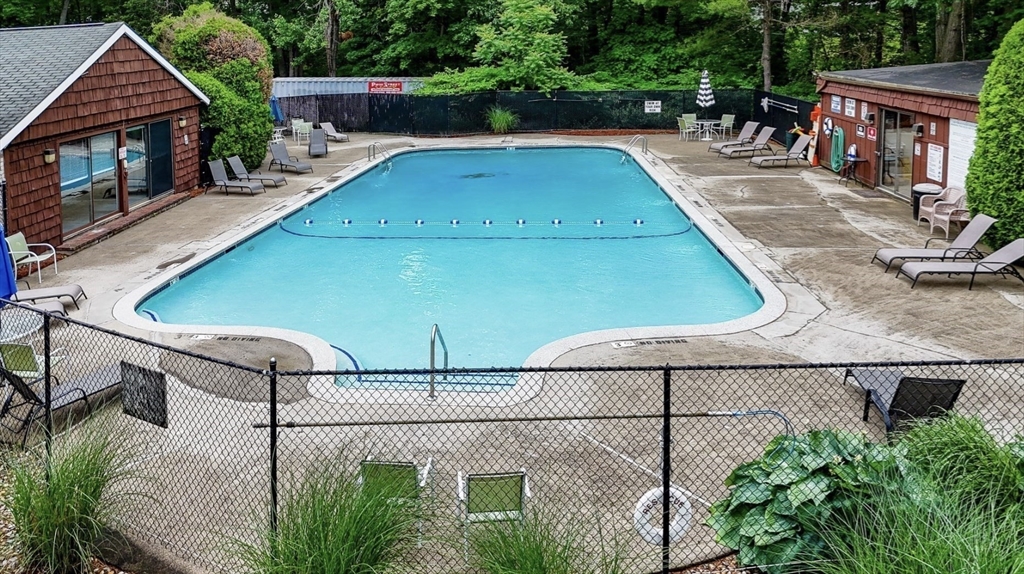 7 Greenbriar Drive, Unit 304 North Reading, MA 01864 - Photo 23 of 23 a view of a swimming pool with potted plants and large tree