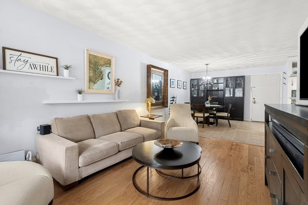7 Greenbriar Drive, Unit 304 North Reading, MA 01864 - Photo 3 of 23 a living room with furniture and a flat screen tv
