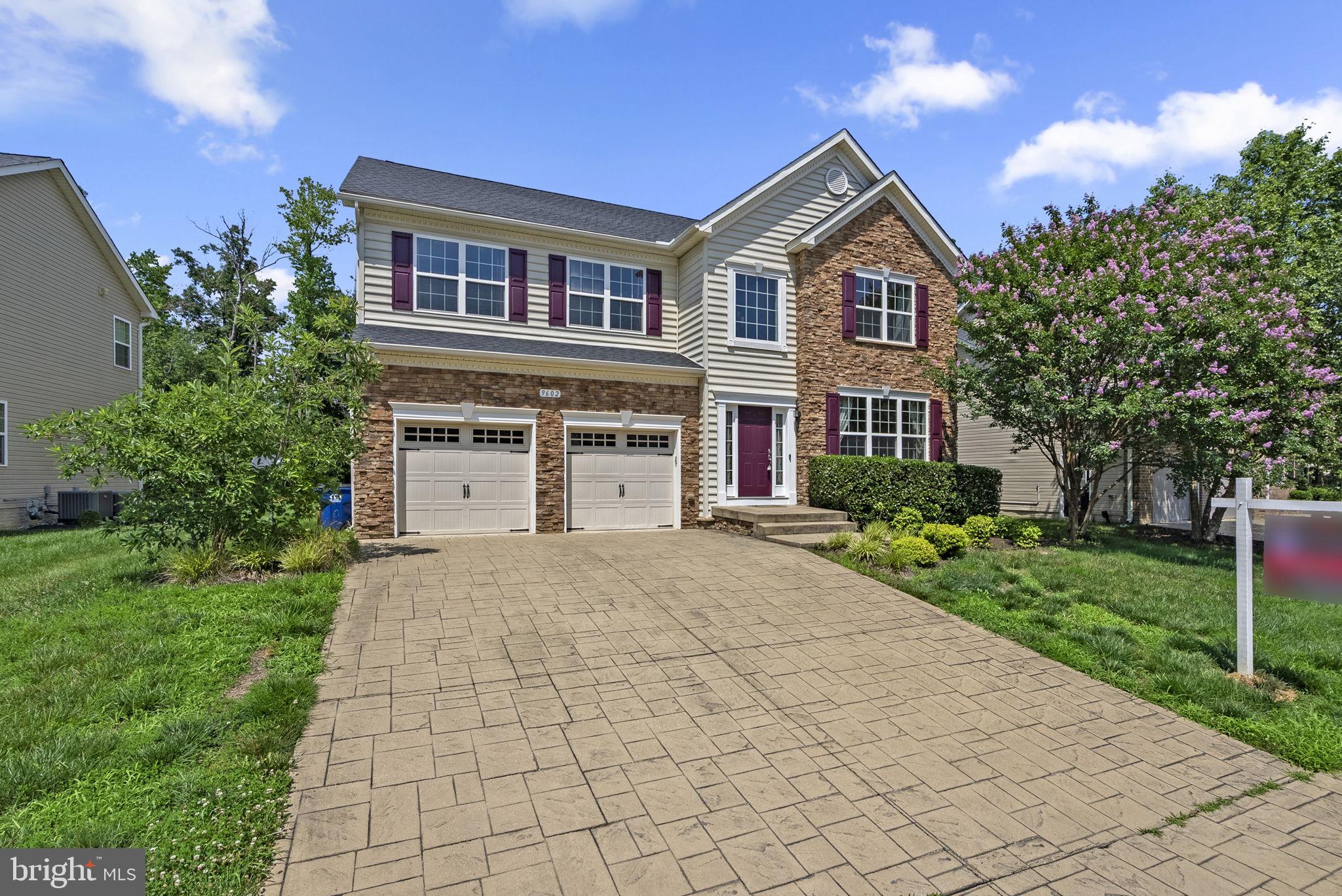 9602 Pep Rally Lane Waldorf, MD 20603 - Photo 1 of 44 a front view of a house with a yard and garage