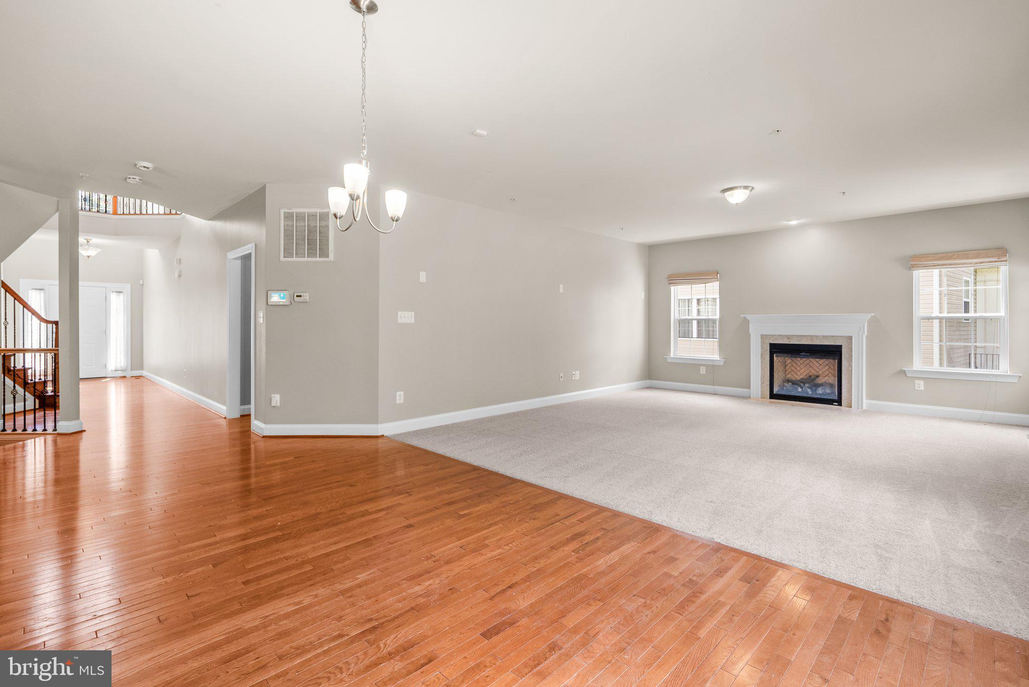 9602 Pep Rally Lane Waldorf, MD 20603 - Photo 11 of 44 a view of empty room with wooden floor and fireplace