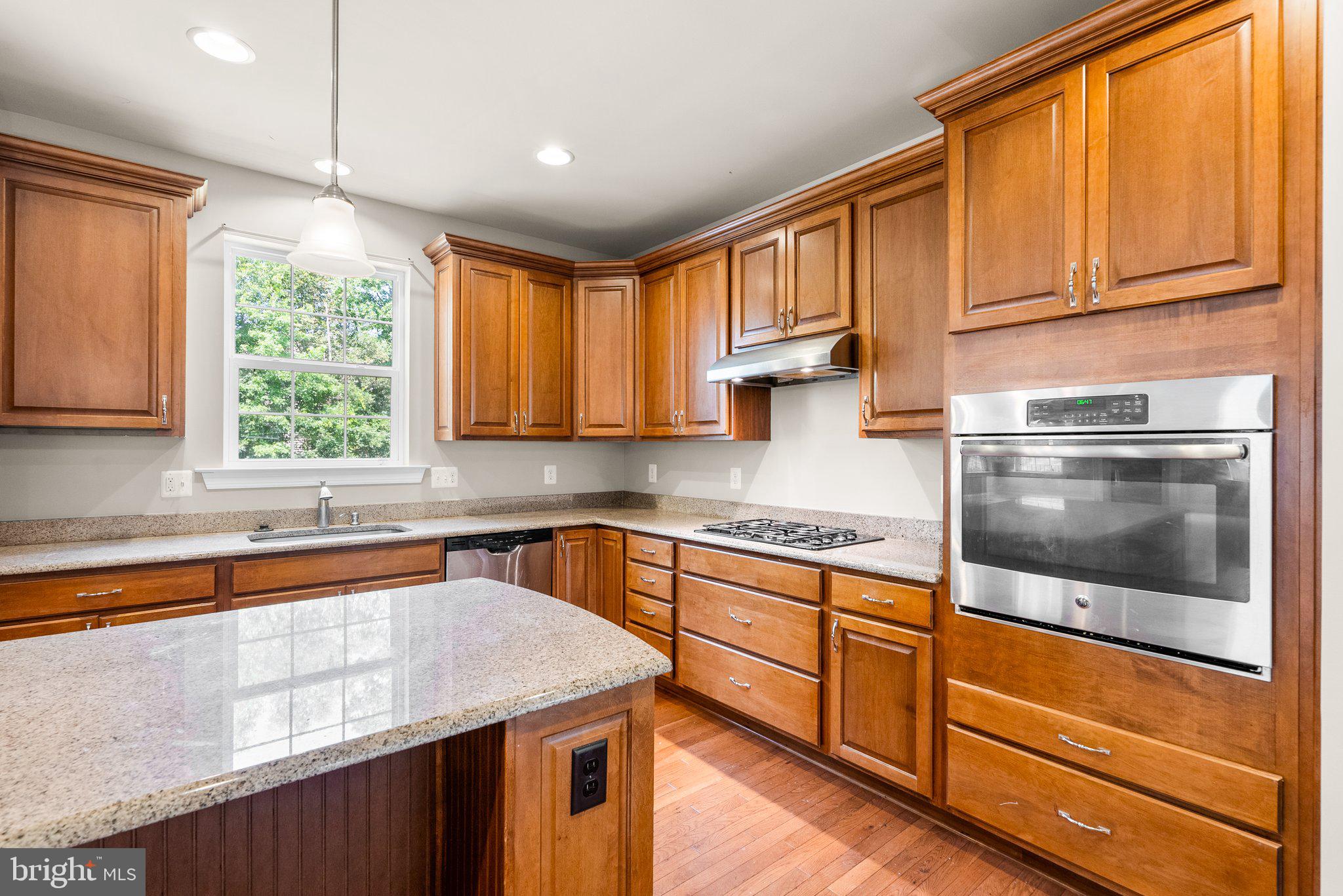 9602 Pep Rally Lane Waldorf, MD 20603 - Photo 15 of 44 a kitchen with stainless steel appliances granite countertop wooden cabinets a sink and a dishwasher
