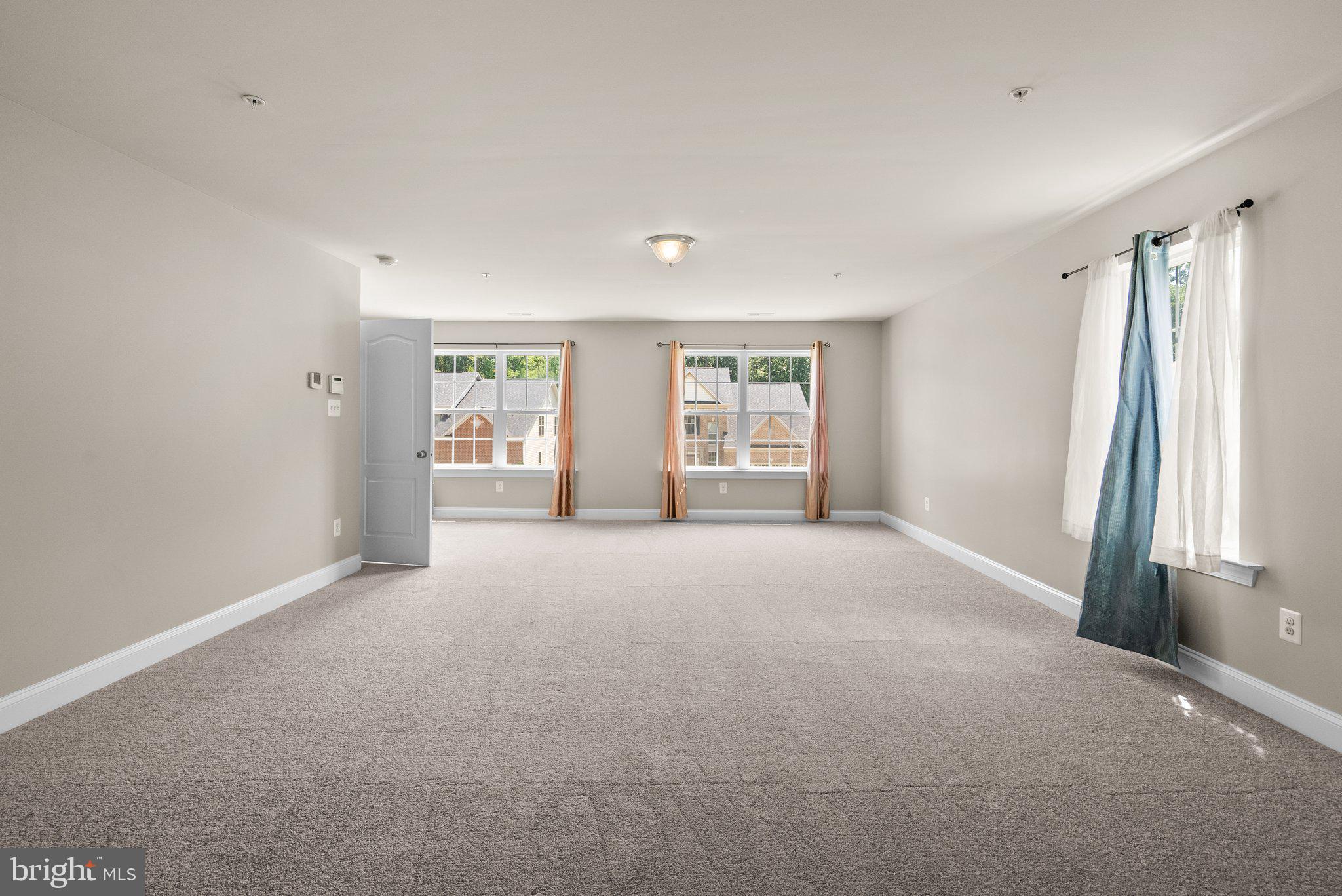 9602 Pep Rally Lane Waldorf, MD 20603 - Photo 24 of 44 a view of a big room with windows and chandelier fan