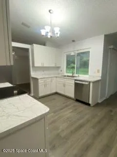 a large kitchen with kitchen island a sink stainless steel appliances and cabinets
