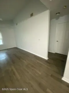 an empty room with wooden floor