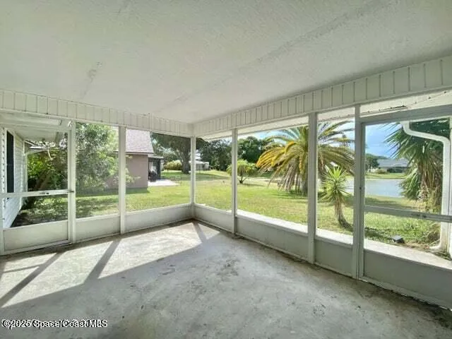 a view of an empty room with floor to ceiling windows and floor to ceiling window
