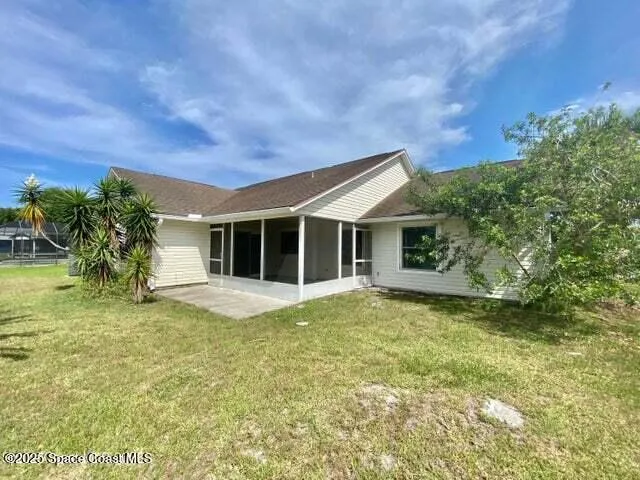 a view of a house with a garden and pathway