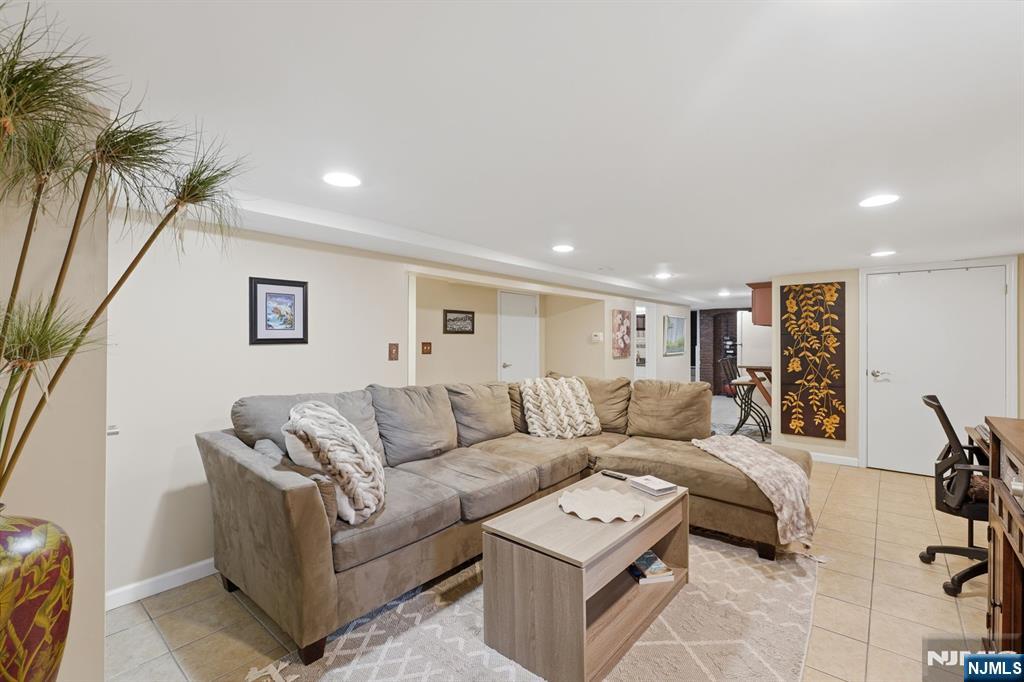 385 Berkeley Avenue Bloomfield, NJ 07003 - Photo 28 of 39 a living room with furniture and a potted plant