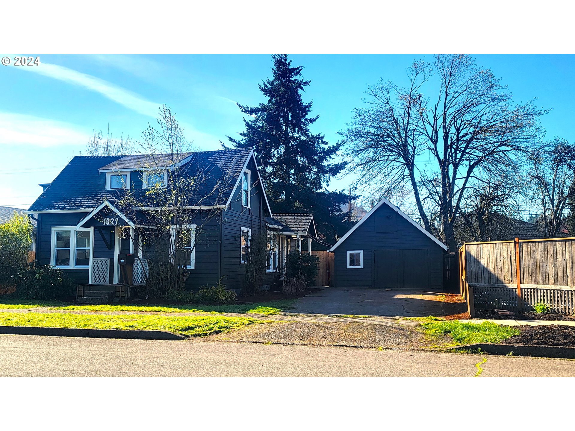 1029 A Street Springfield, OR 97477 - Photo 1 of 27 a view of a big house with a big yard and large tree