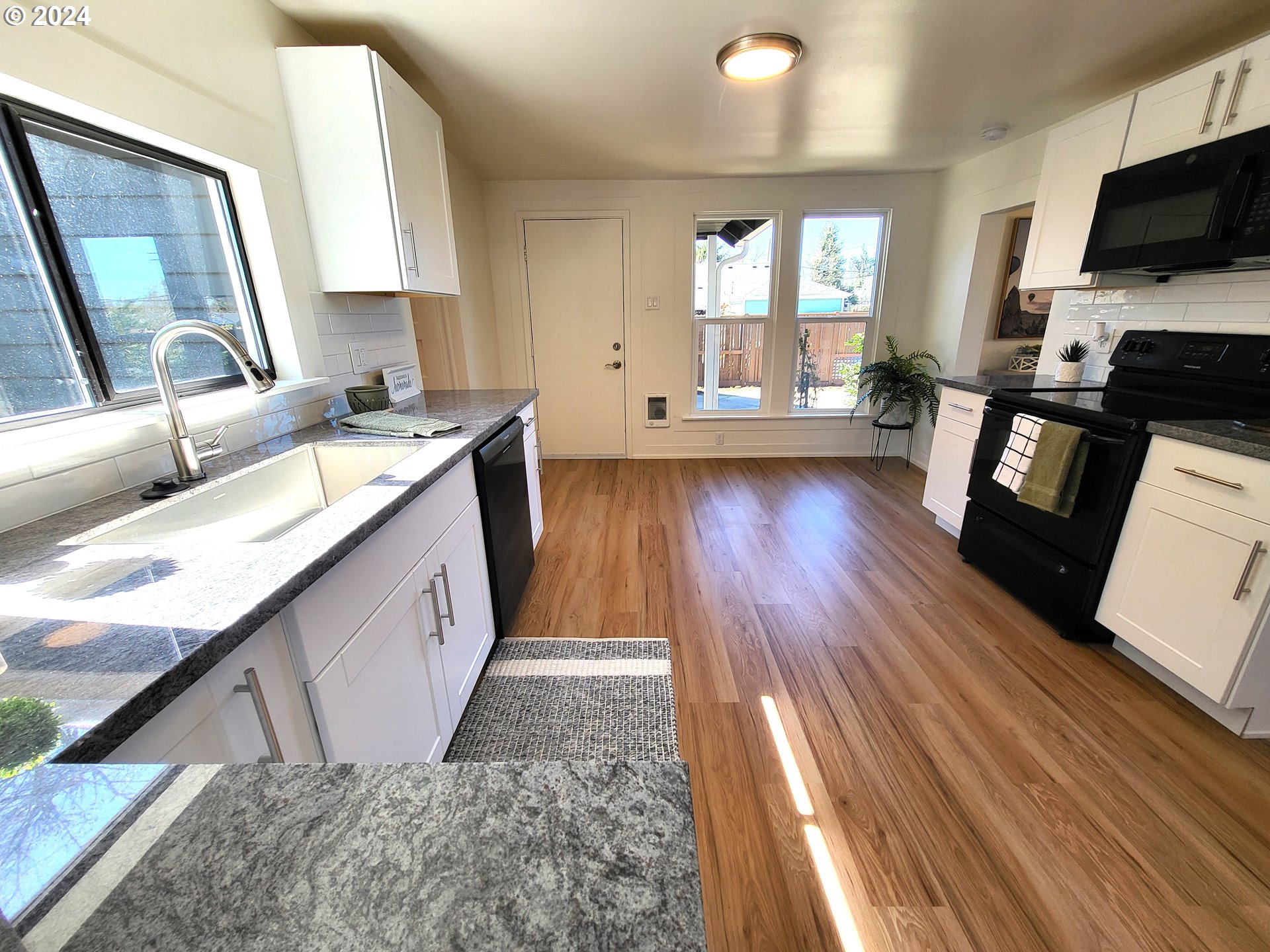 1029 A Street Springfield, OR 97477 - Photo 15 of 27 a kitchen with sink a stove and wooden floor
