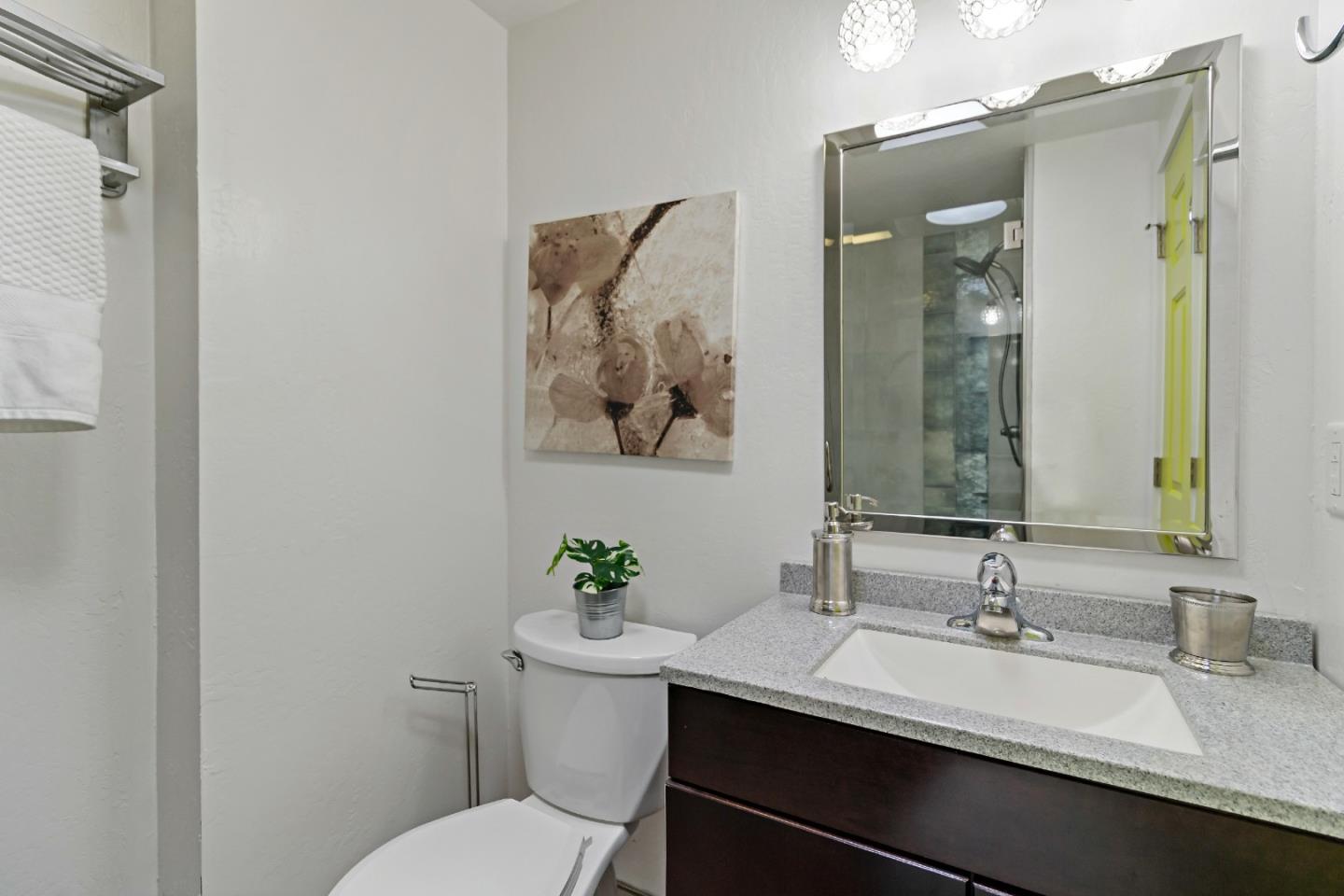 1502 Petersen Avenue San Jose, CA 95129 - Photo 46 of 56 a bathroom with a granite countertop sink a toilet and a mirror