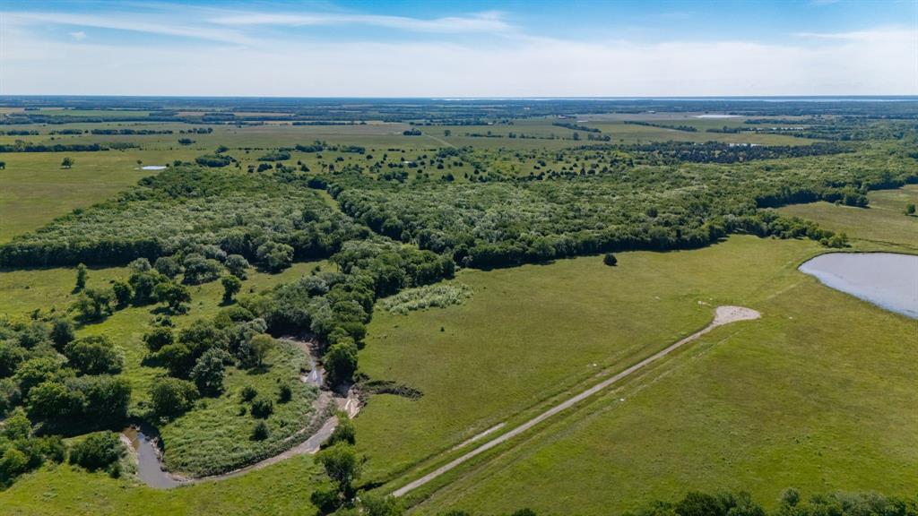 1625 Fm 904 Street South, Unit ES Commerce, TX 75428 - Photo 3 of 22 an aerial view of a golf course with a yard