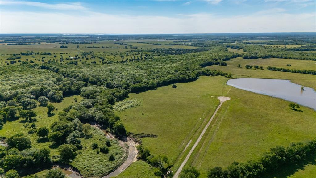 1625 Fm 904 Street South, Unit ES Commerce, TX 75428 - Photo 4 of 22 an aerial view of a residential houses with outdoor space and trees all around