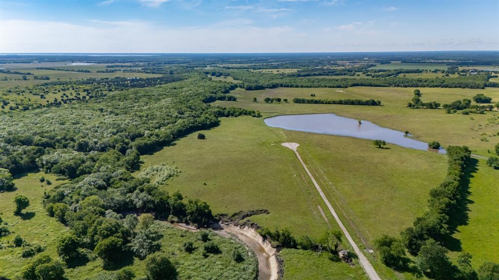 1625 Fm 904 Street South, Unit ES Commerce, TX 75428 - Photo 5 of 22 an aerial view of a residential houses with outdoor space and trees all around