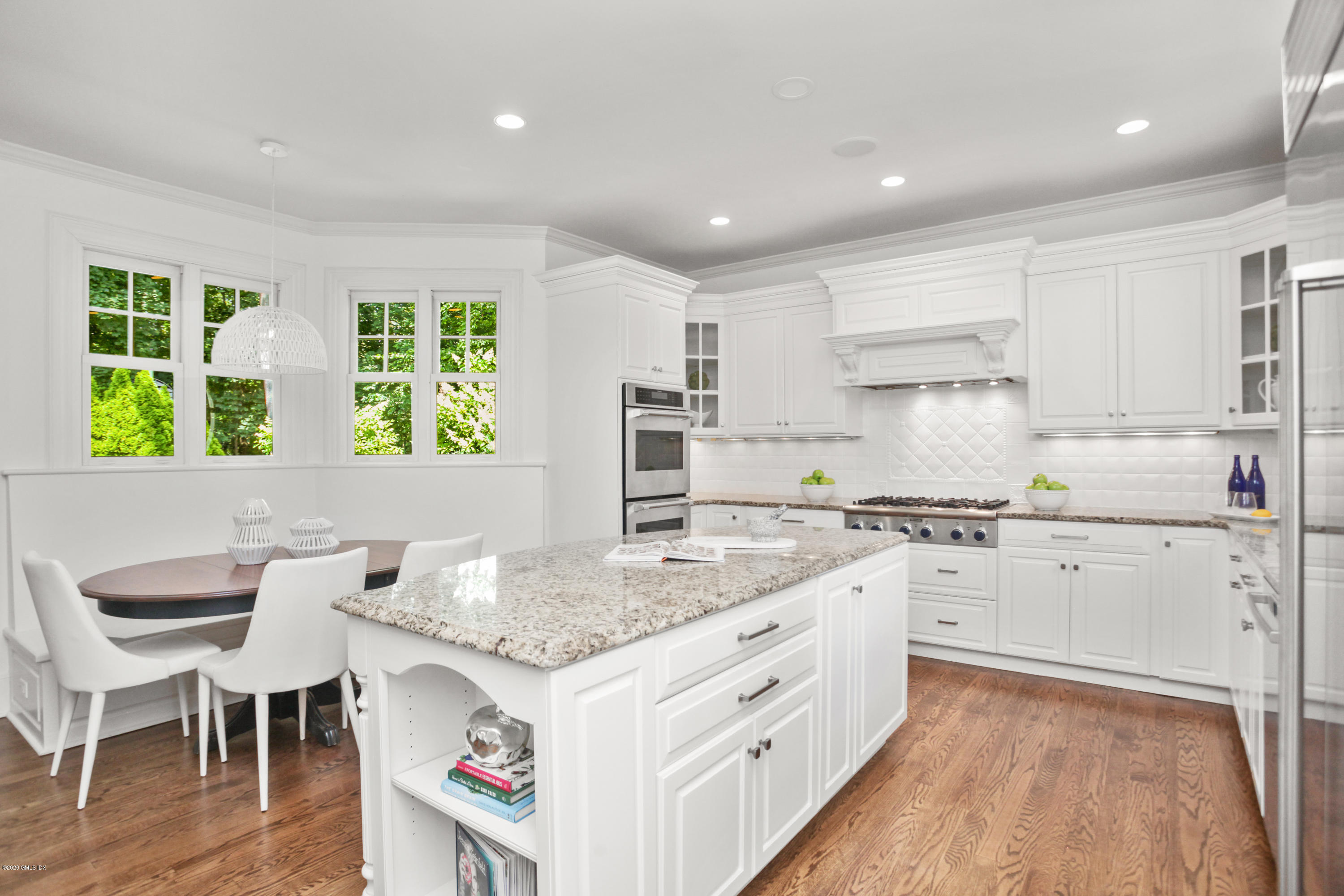 29 Weston Hill Road Riverside, CT 06878 - Photo 15 of 39 a kitchen with granite countertop white cabinets and stainless steel appliances