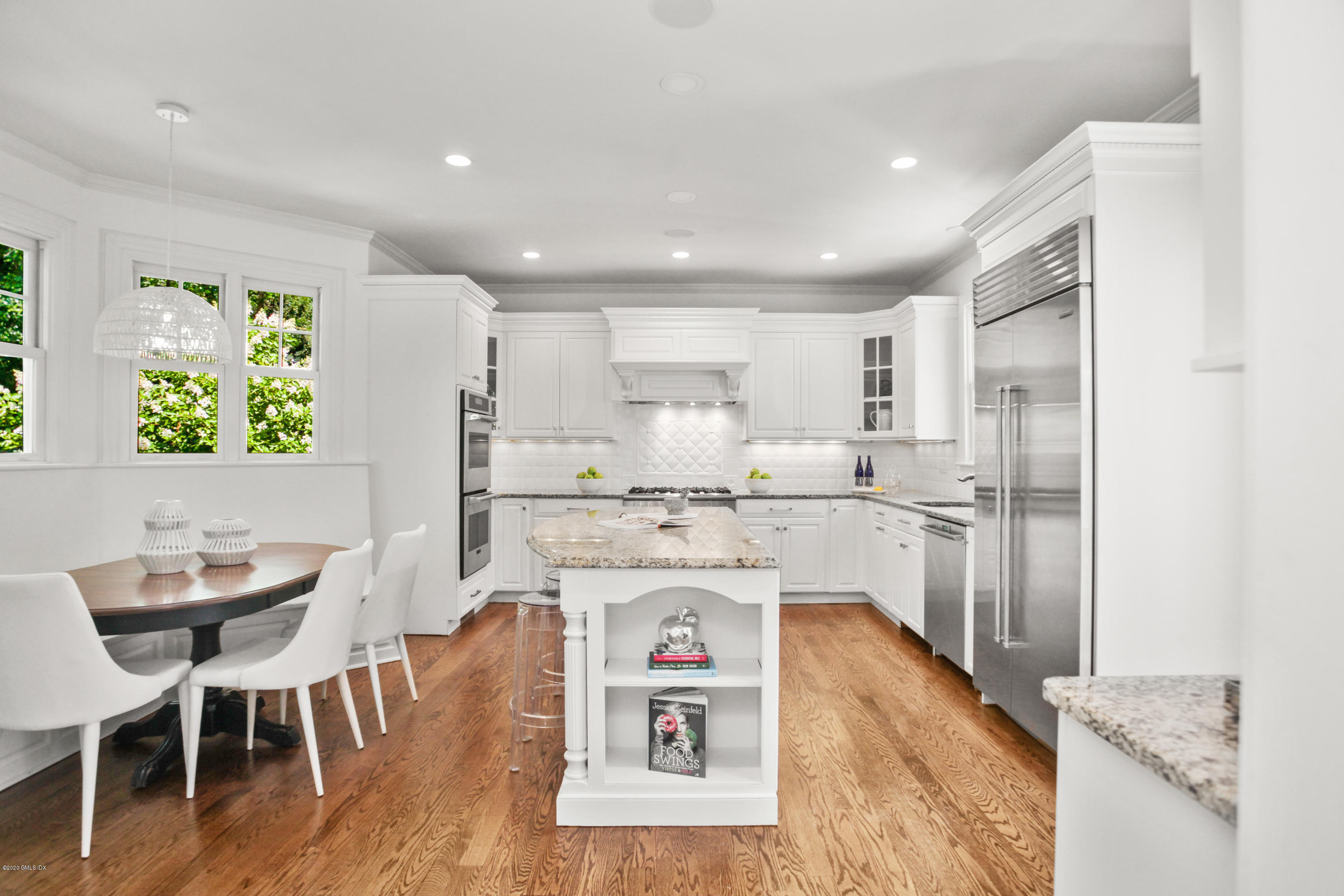 29 Weston Hill Road Riverside, CT 06878 - Photo 16 of 39 a kitchen with kitchen island a stove a table and chairs