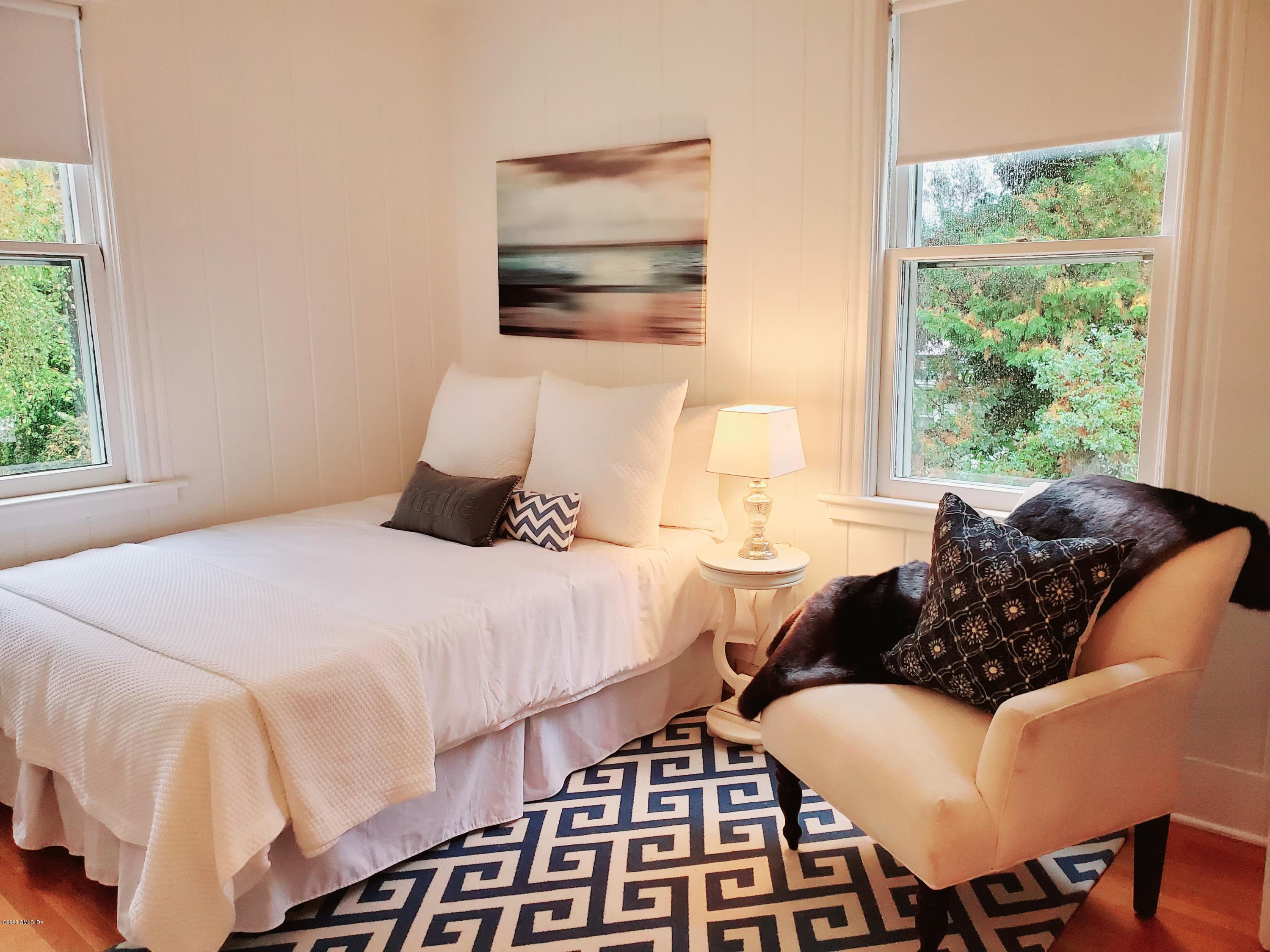 29 Weston Hill Road Riverside, CT 06878 - Photo 29 of 39 a bedroom with a bed and wooden floor