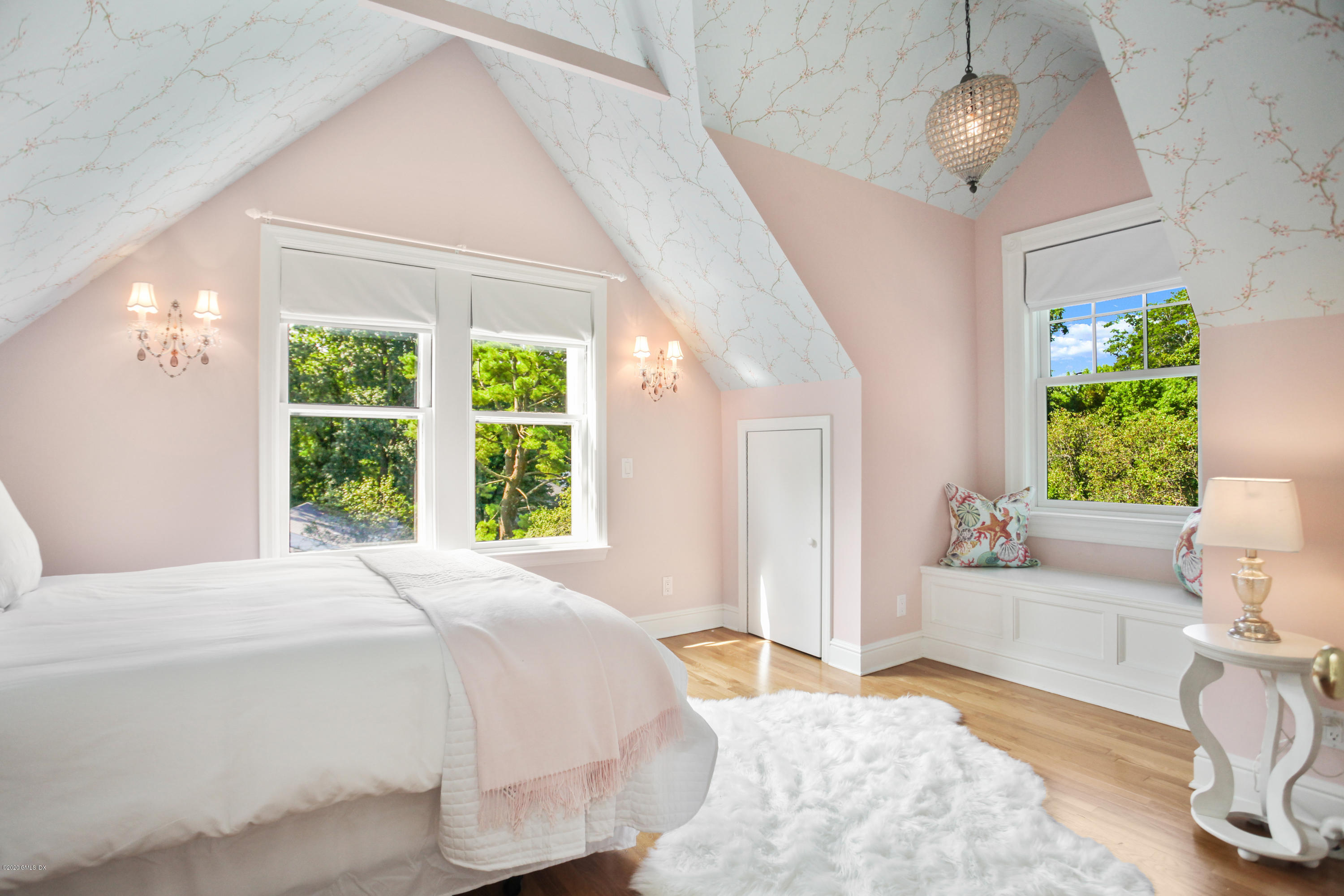 29 Weston Hill Road Riverside, CT 06878 - Photo 31 of 39 a spacious bedroom with a bed and a chandelier