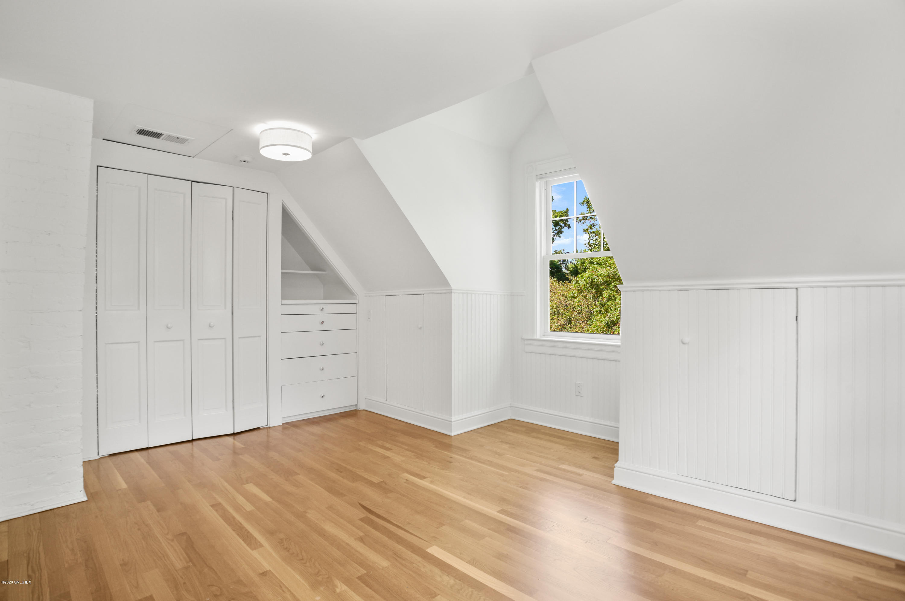 29 Weston Hill Road Riverside, CT 06878 - Photo 34 of 39 an empty room with wooden floor closet and windows
