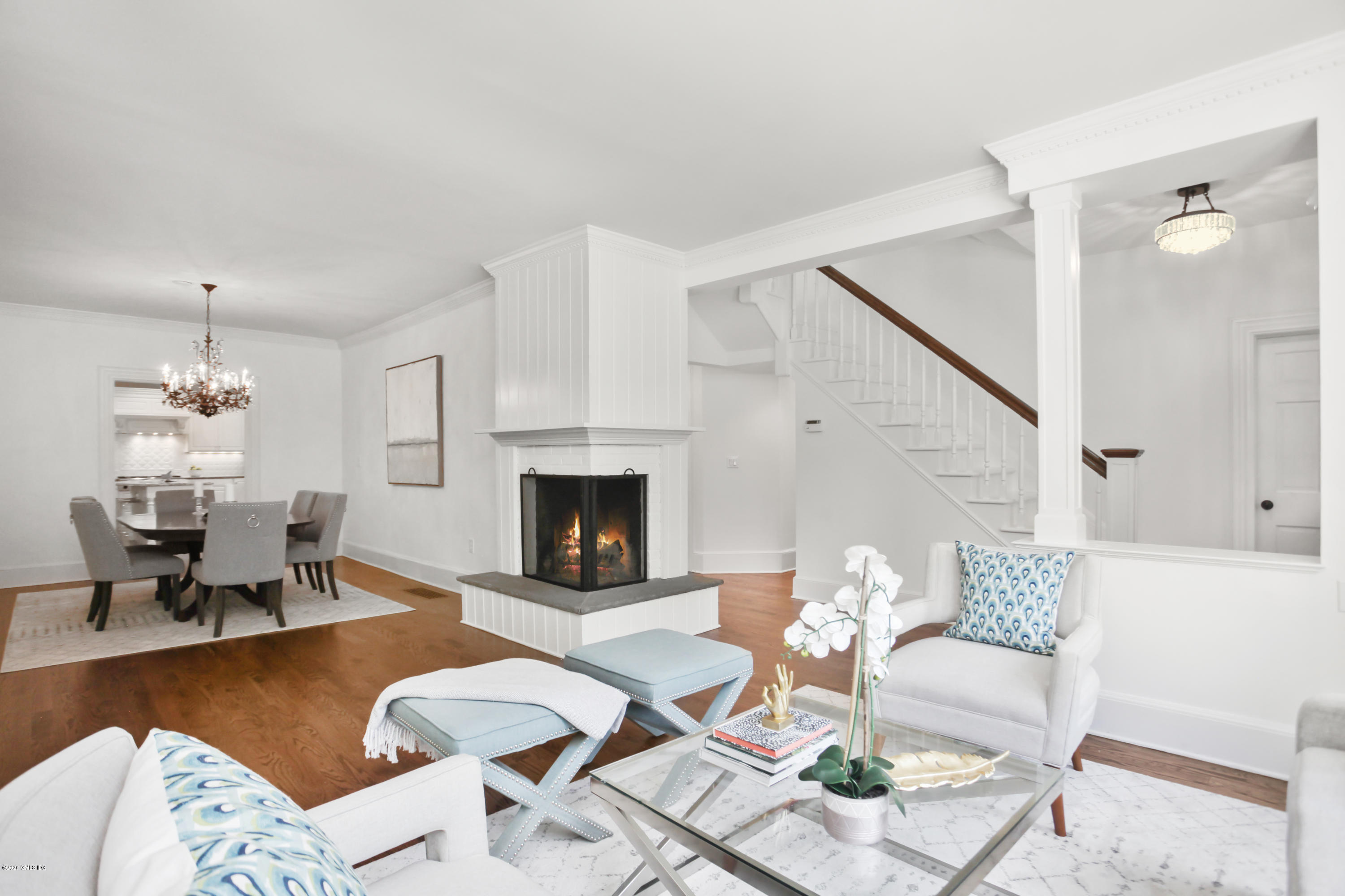 29 Weston Hill Road Riverside, CT 06878 - Photo 6 of 39 a living room with furniture a fireplace and a chandelier