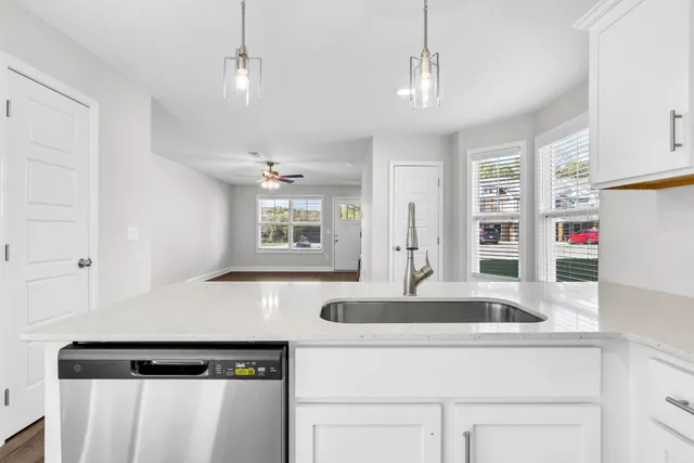 a kitchen with a sink and a refrigerator