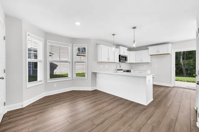 a view of kitchen with wooden floor and window